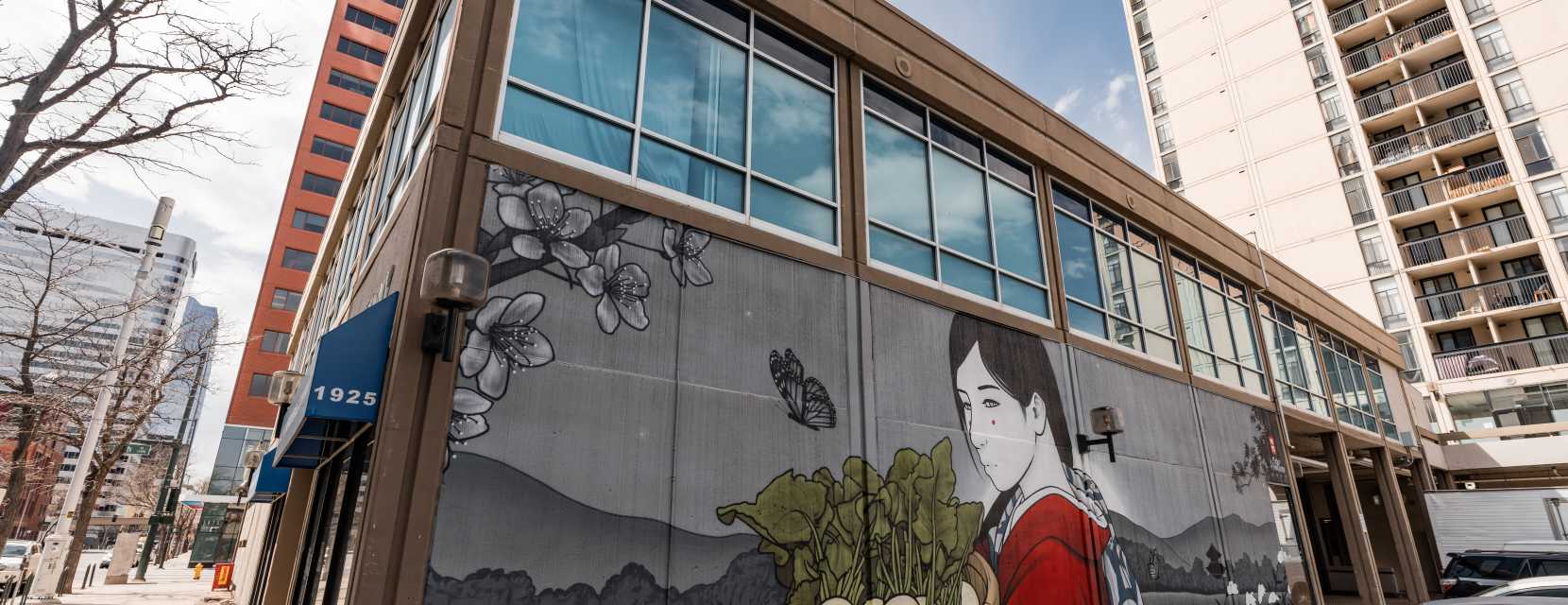 A large street art mural on the side of a building in Sakura Square in Denver, Colorado.