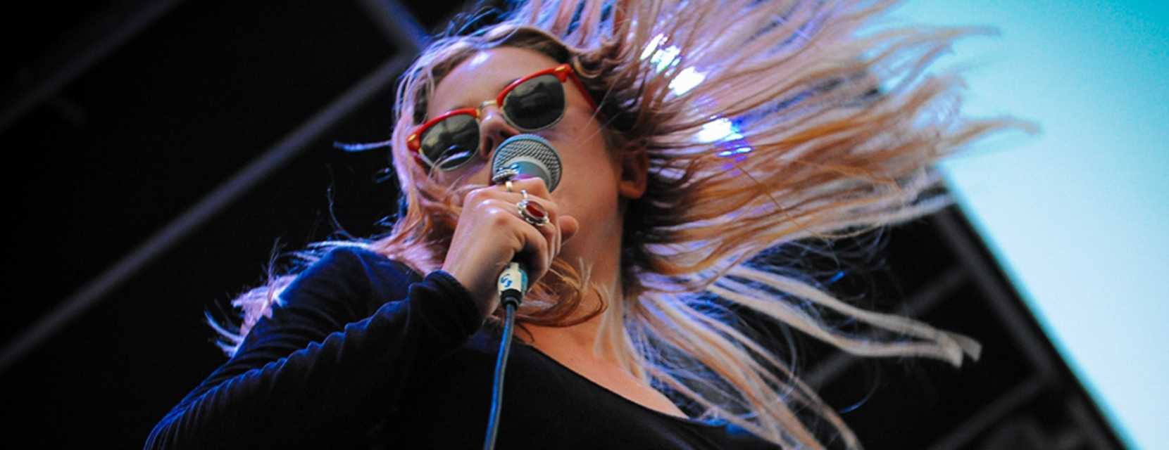 Woman singing at Denver's Underground Music Showcase