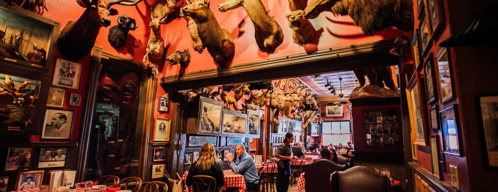 People sit at a table surrounded by taxidermy at Buckhorn Exchange