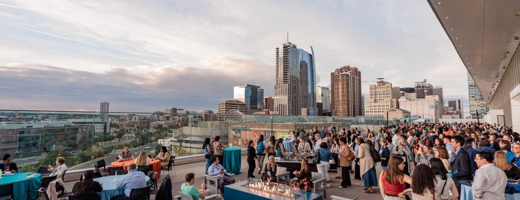 People talk on a terrace at Colorado Convention Center