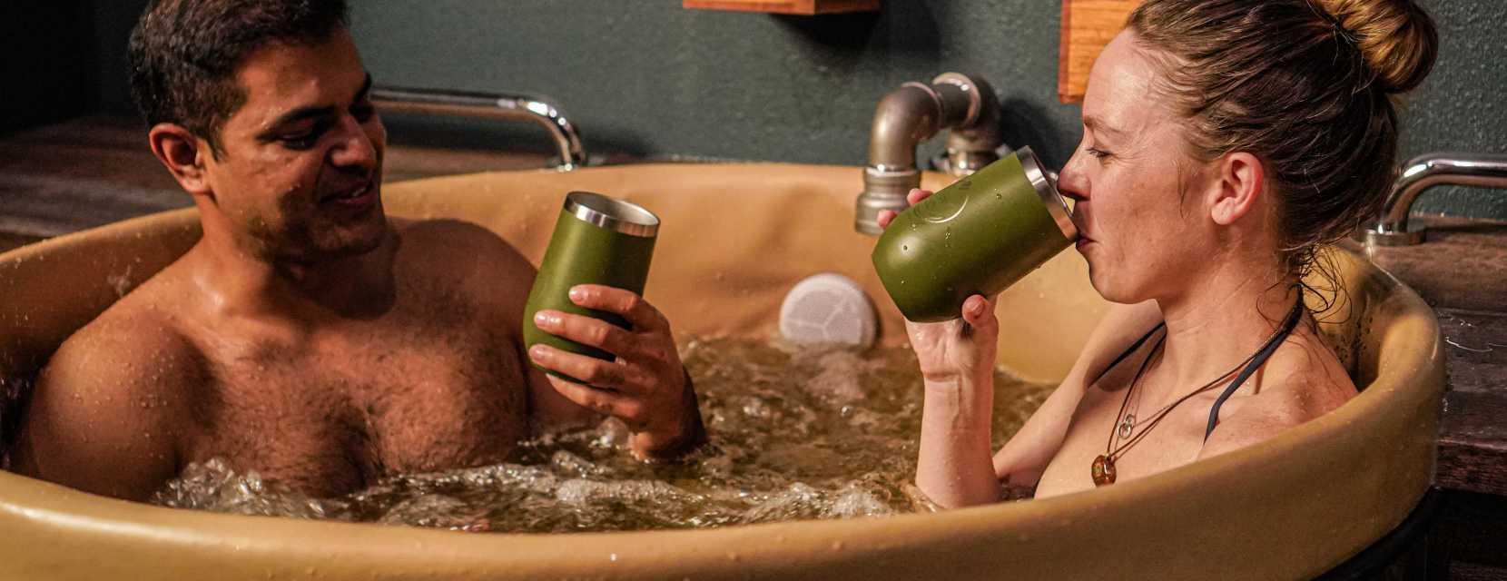 A couple sips beer in a tub at Oakwell Beer Spa