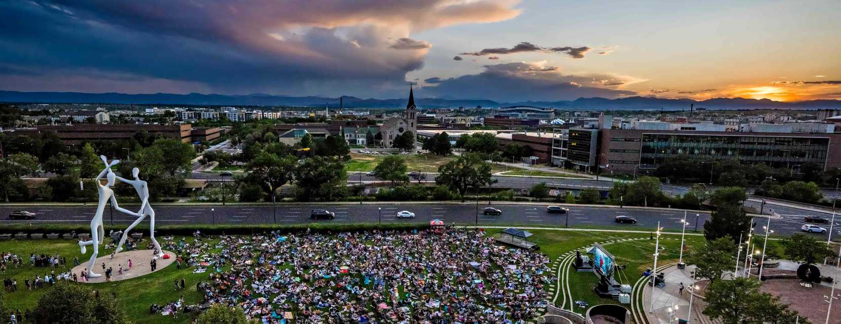 An aerial view of the Denver sculpture park at sunset during an outdoor movie screening