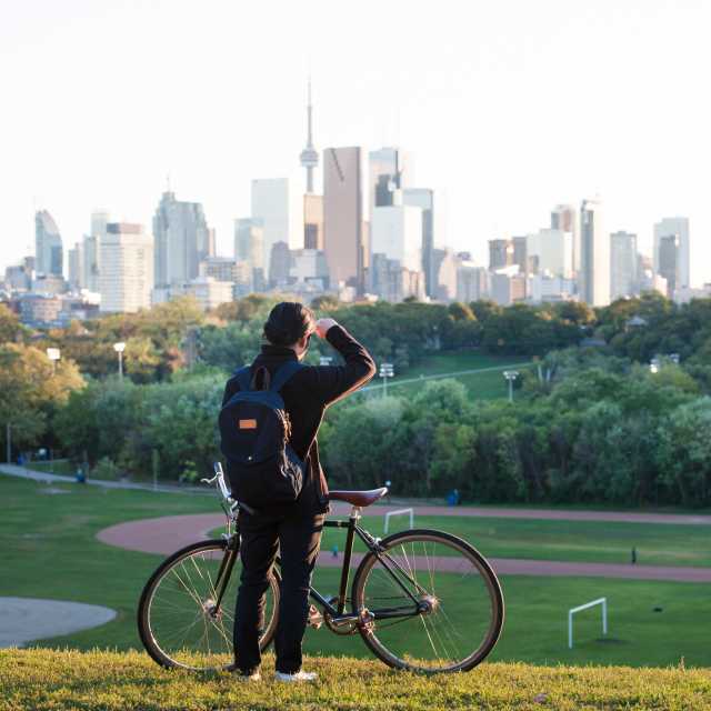 A person looks at the Toronto skyline from Riverdale Park in Toronto's east end