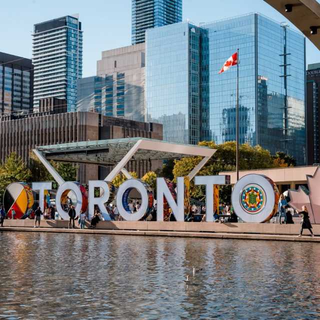 Toronto Sign City Hall on a sunny day with buildings behind