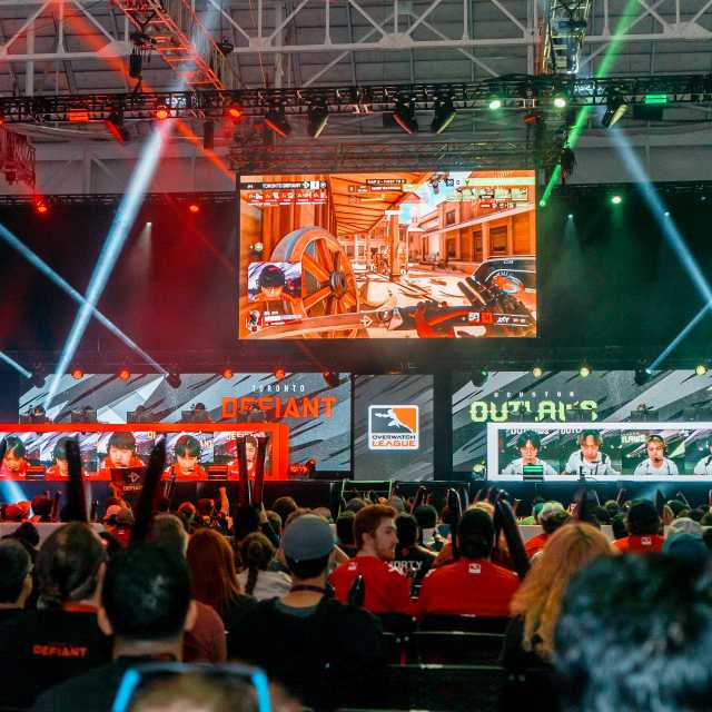 Esports Tournament Competitors at play in the background and crowd