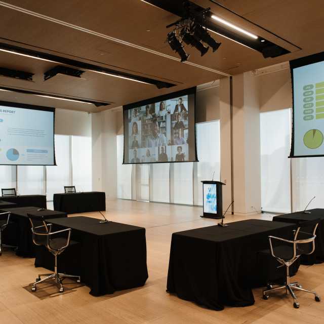 Tables and chairs set up inside a meeting space at the Globe and Mail Centre