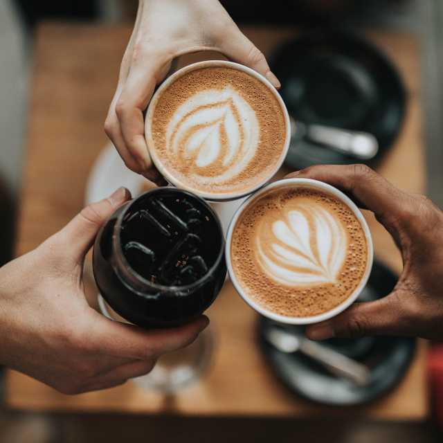 Three coffee cups with latte art
