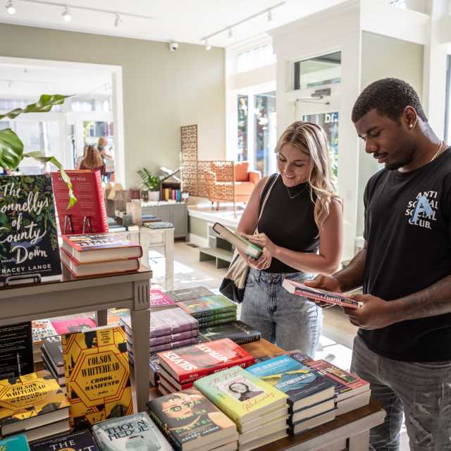 two people checking out some books at Bound Books