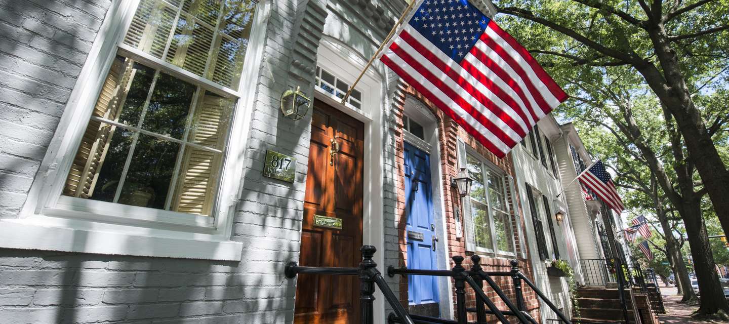 American Flags Hanging From Old Town Buildings