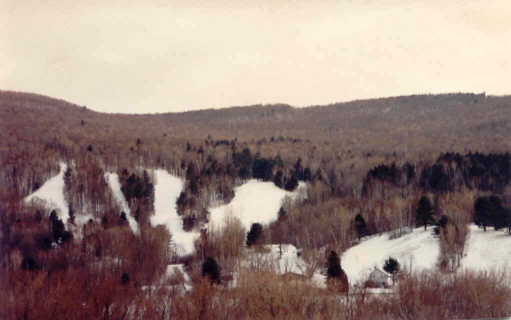 Photo courtesy of Vermont Ski & Snowboard Museum - Mickey started cutting trees. With the hillside cleared, he rigged up a 400-foot rope tow behind the house using an old tractor engine, and strung lights to illuminate the slopes so he and Ginny and their four kids could ski after school and work. The Cochran’s opened their home and their backyard to the townspeople. Their kitchen became the ski area’s unofficial warming hut, and one of America’s most legendary community-based ski areas was born. 