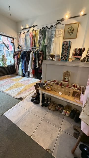 A vintage shop in Frostburg MD features a wall of dresses and tops.
