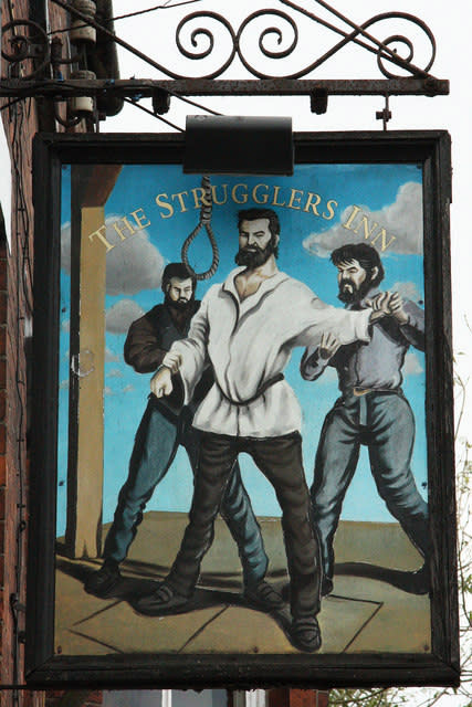 Image shows The Strugglers Pub sign.