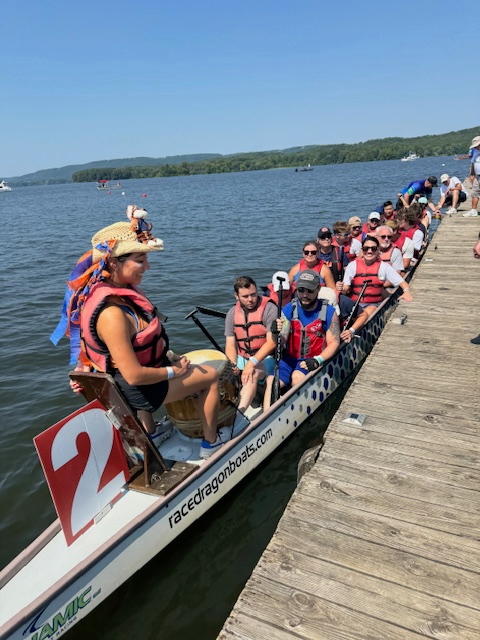 A team of 20 paddlers, a drummer and a steerer await their turn to race in a 46-foot-long traditional dragon boats on Lake Guntersville during the Scottsboro Dragon Boat Race and Festival.