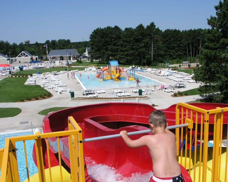 kid going down waterslide at park