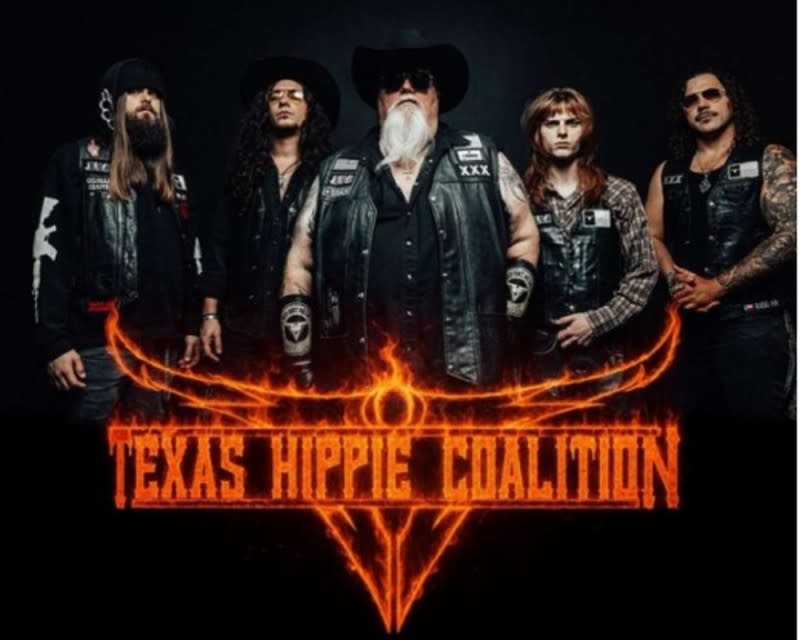 The members of Texas Hippie Coalition pose in leather vests and jackets for a photo in dark light with "Texas Hippie Coalition" text in a bright orange flame font.