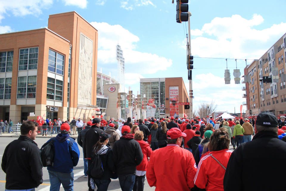 A crowd of Cincinnati Reds fans in the Opening Day parade, heading into the Great American Ballpark