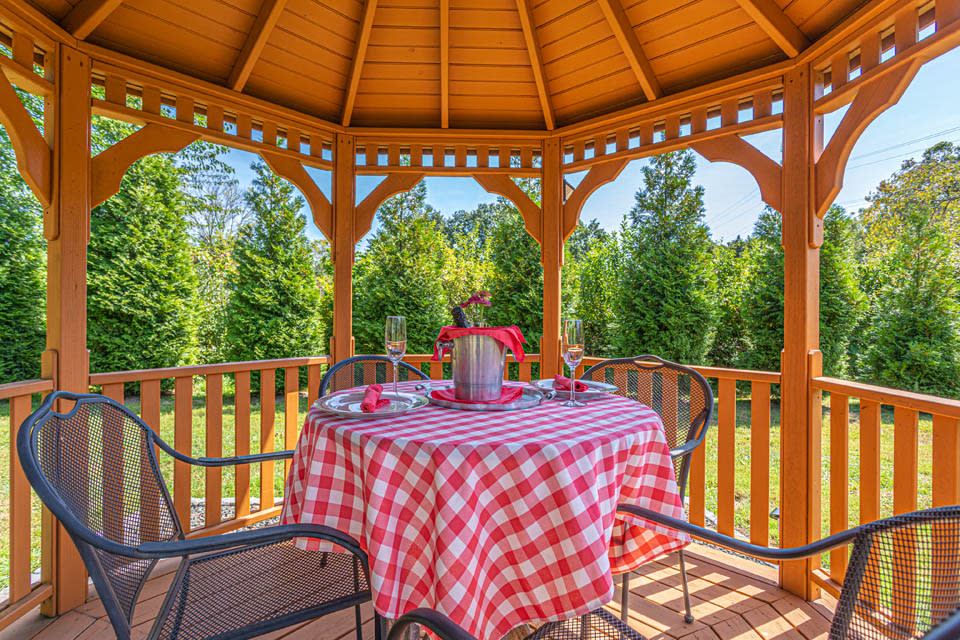 Table and chairs under a gazebo to dine