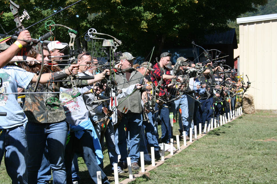 bow hunters lineup row aiming they arrows