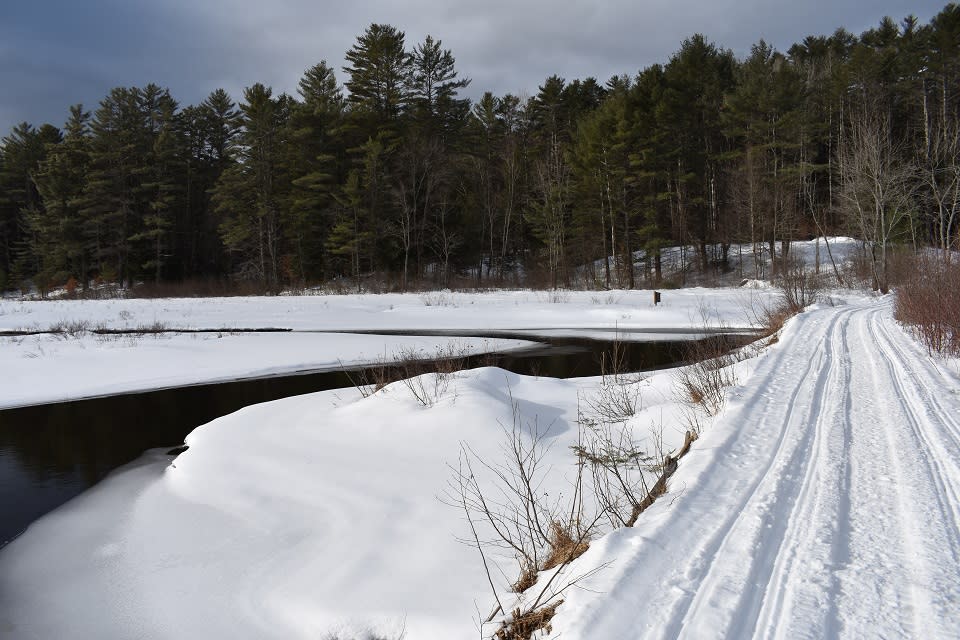 Bridge on the Chester Creek Trails covered in cross country ski trackswith Chester Creek to the left
