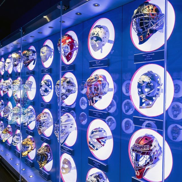 A wall of hockey helmets at the Hockey Hall of Fame