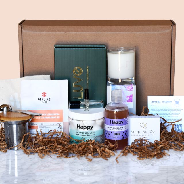 Butterfly Ethical Gifting Wellness Gift Box, with tea soap candles and other product displayed in front of a brown box