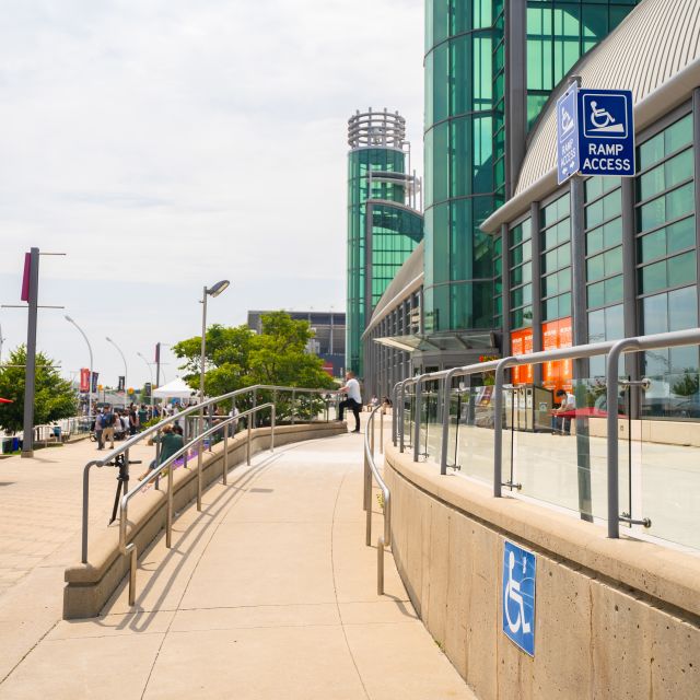 Exhibition Place Accessible Entrance. Image shows a ramp with a 'ramp access' signage on the side of the building