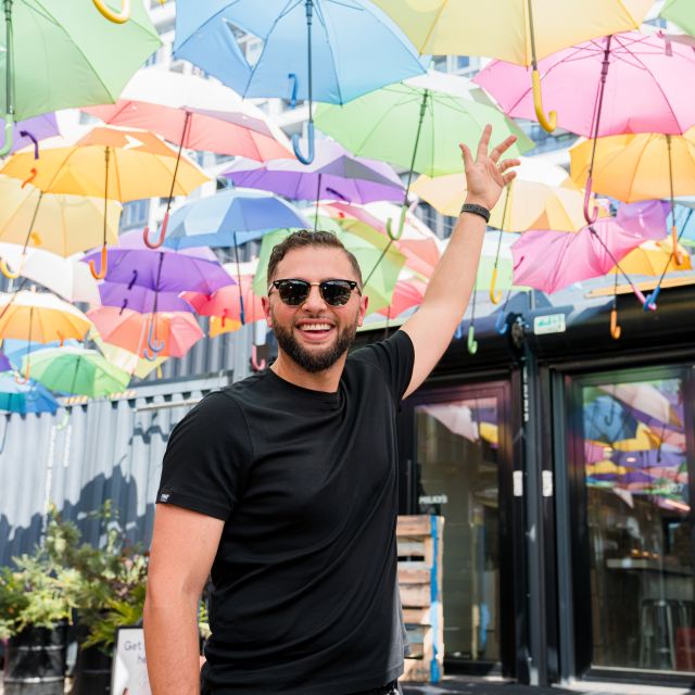 Abdullah Snobar at Stackt under colorful umbrella instaltion