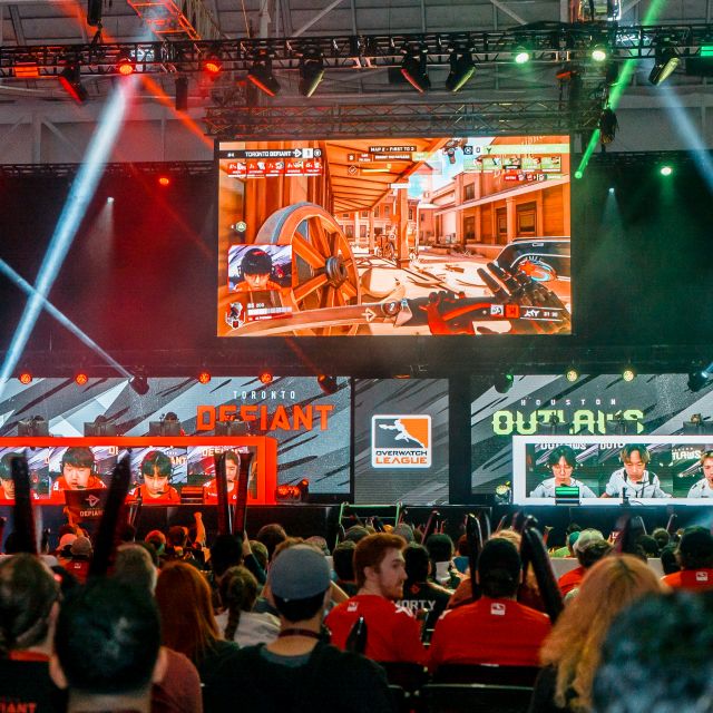 Esports Tournament Competitors at play in the background and crowd