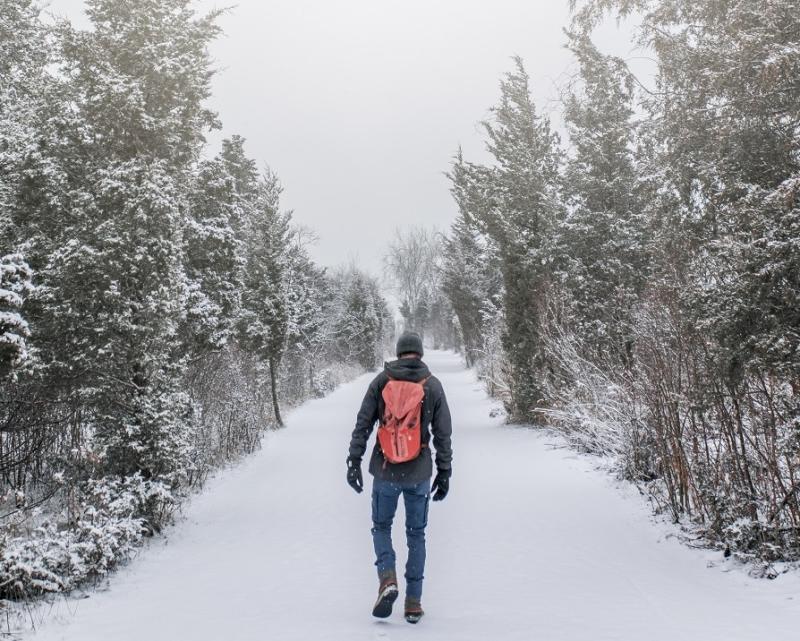 man walking on winter trail