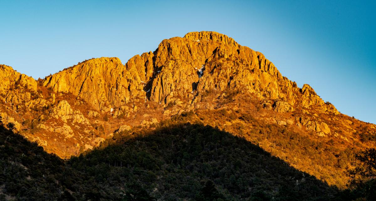 Santa Rita mountains in Tucson during golden hour - a shadow cast along the bottom of the range