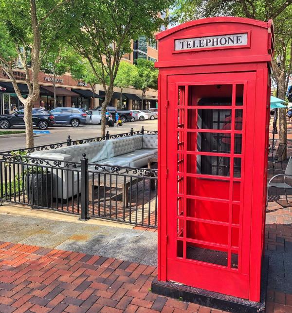 Iconic red photo booth in front of Baker St. Pub & Grill.