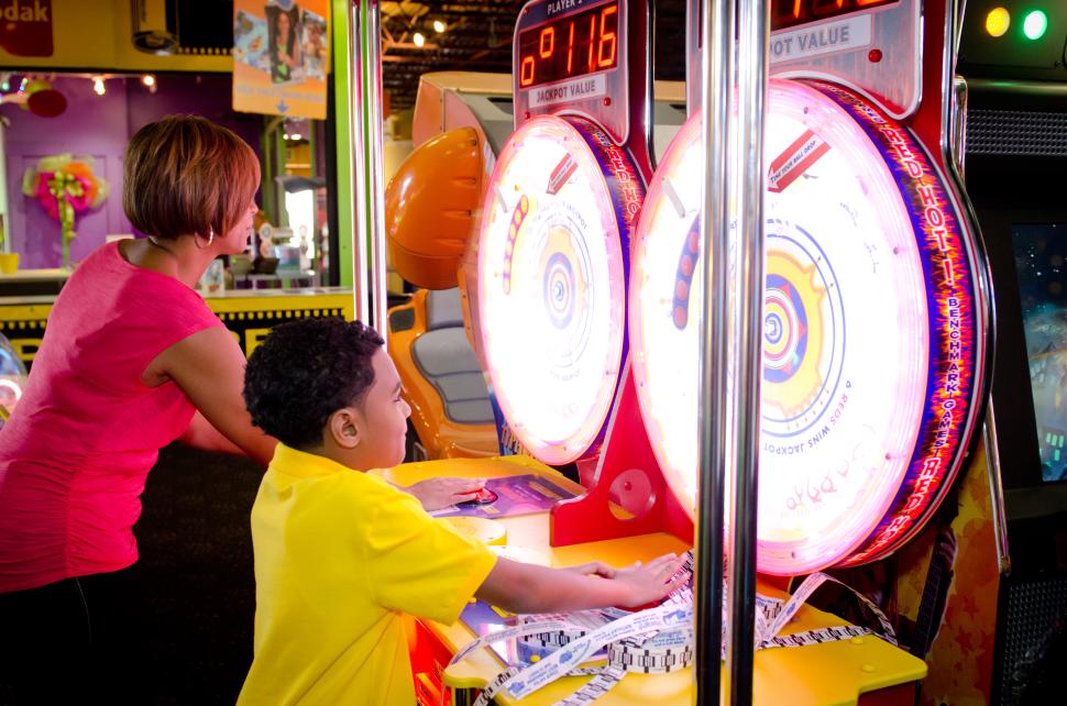 A mother and son play arcade games at All Star Adventures in Wichita, KS.