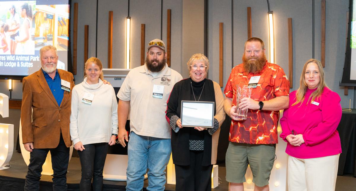 Living Treasures Wild Animal Park representatives receive the Pathfinder Award at GO Laurel Highlands' annual dinner at The Venue at Live! Casino in Greensburg.