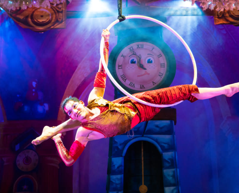 A performer hangs in a loop during a Cirque Dreams performance