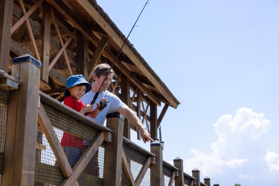 A father and son fish together.