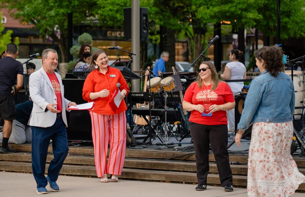 Nick Wolda, Elizabeth Eddins, and Amber Parsley award Katrina Lockler with a Hospitality Award during a National Travel and Tourism Week pop-up event at Market Street.