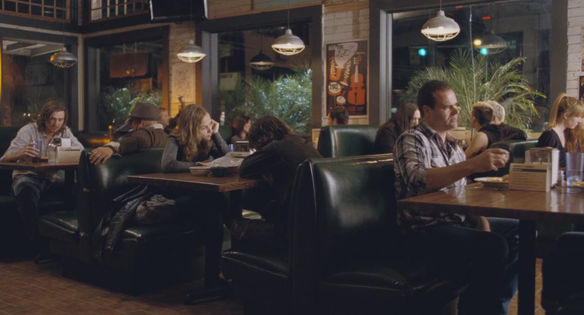 Boyhood screengrab, showing Mason and Sheena eating queso at a booth inside Magnolia Cafe