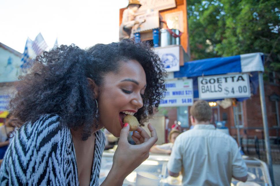 Woman eating goetta balls at a street festival (photo: CincinnatiUSA.com)