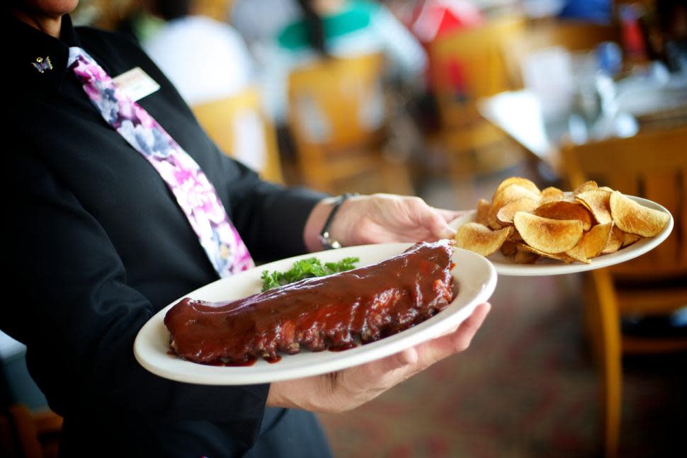 Server carrying ribs at Montgomery Inn (photo: Montgomery Inn)