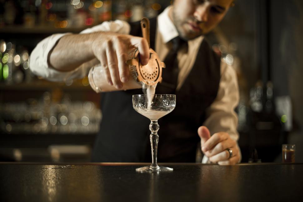 Man pours drink at Dockum