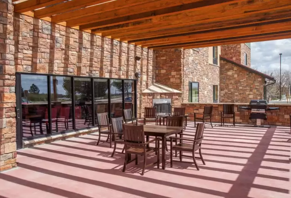 Outdoor seating at the TownePlace Suites in Cheyenne, WY, a pet-friendly hotel that welcomes dogs of all sizes.