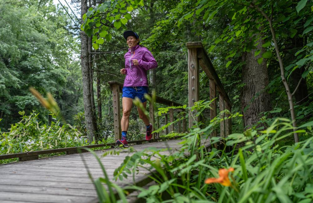 Woman running across bridge in Montreat