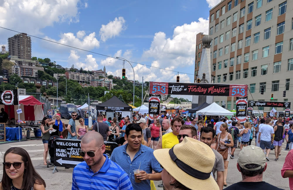 A group of people are wandering downtown Cincinnati during the Taste of Cincinnati festivals