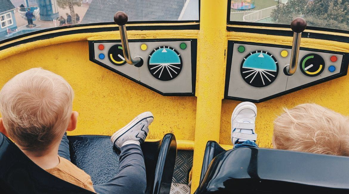 Two young boys sitting in yellow helicopter ride in Paultons Park credit alice spake