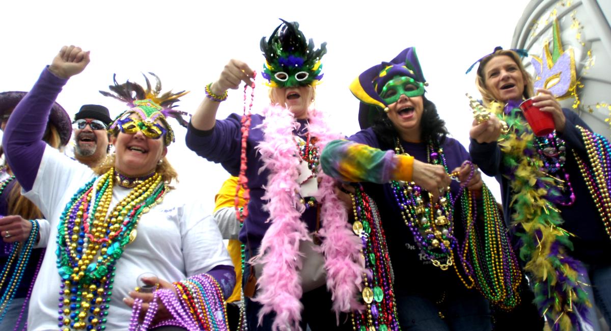 People dressed with masks and beads for Mardi Gras