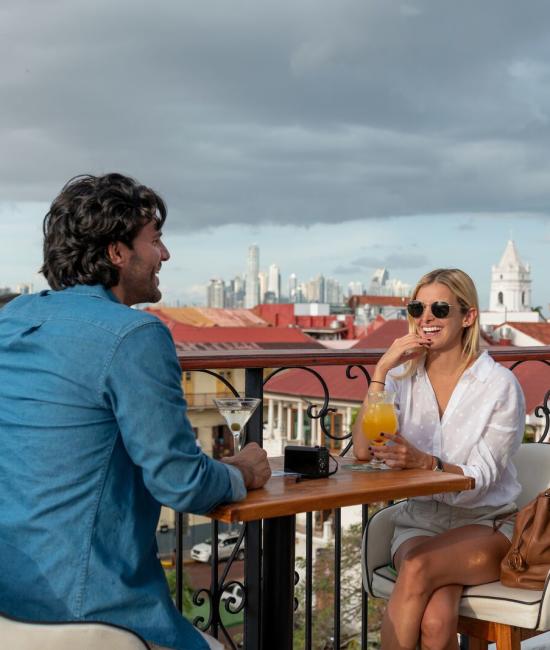 Couple enjoys drinks from rooftop restaurant, Casco Antiguo, Panama City