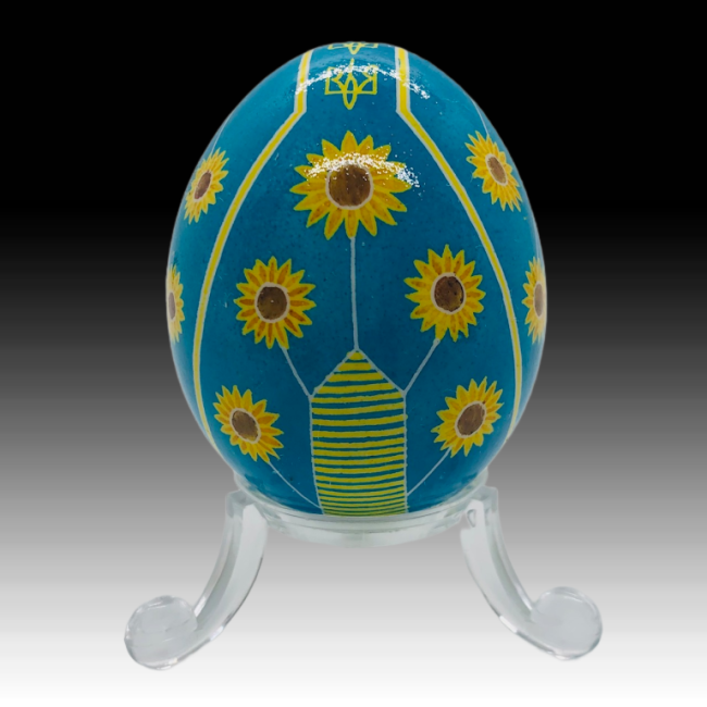 blue egg painted with yellow sunflowers on acrylic stand