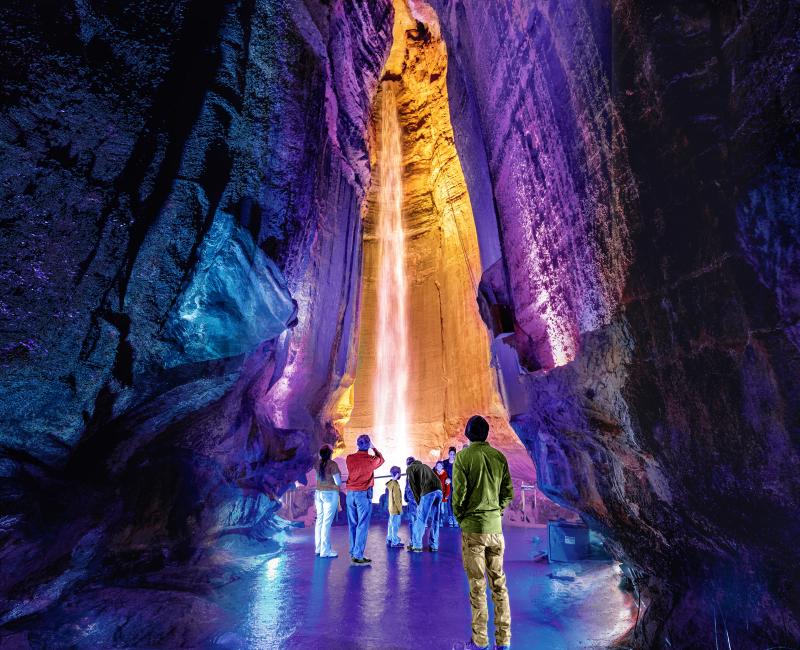Visitors stop to look up at Ruby Falls all lit up