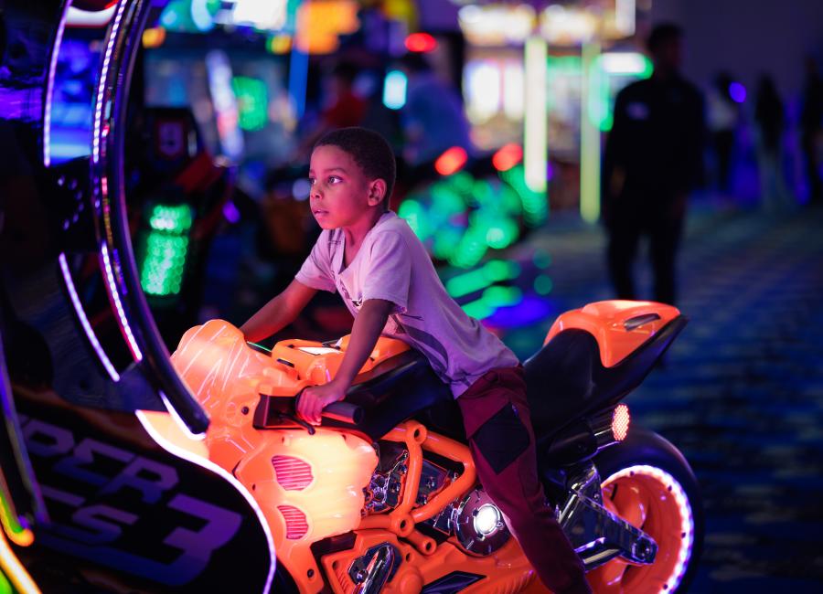 A child playing a video game at Andretti Indoor Karting & Games