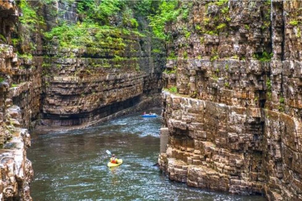 Asuable Chasm A picture of a person kayaking in the Ausable Chasm River